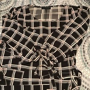 Eloquii black dress with pink checker pattern.